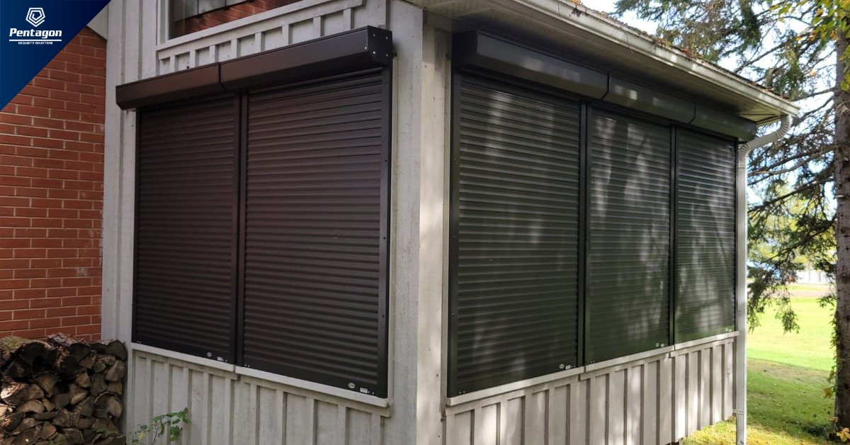 The exterior of a residential porch enclosed with roll-down security shutters covering multiple window openings.